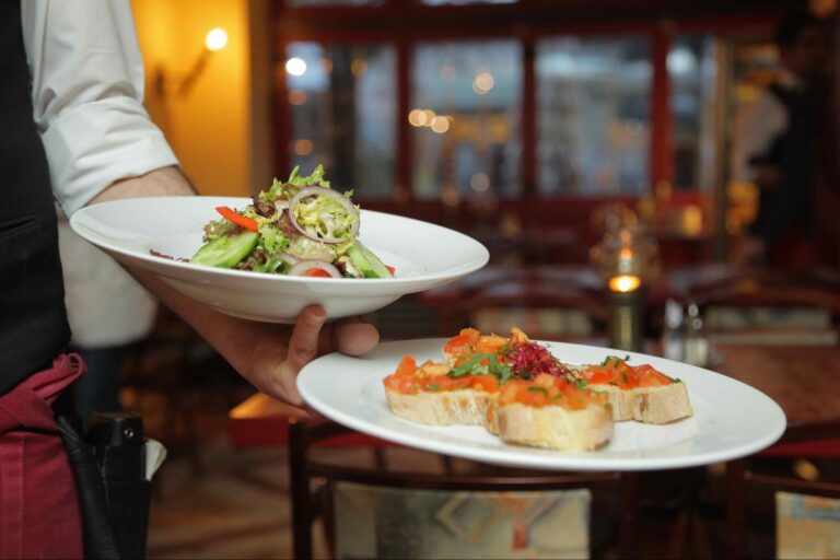 Server holding two plates of food